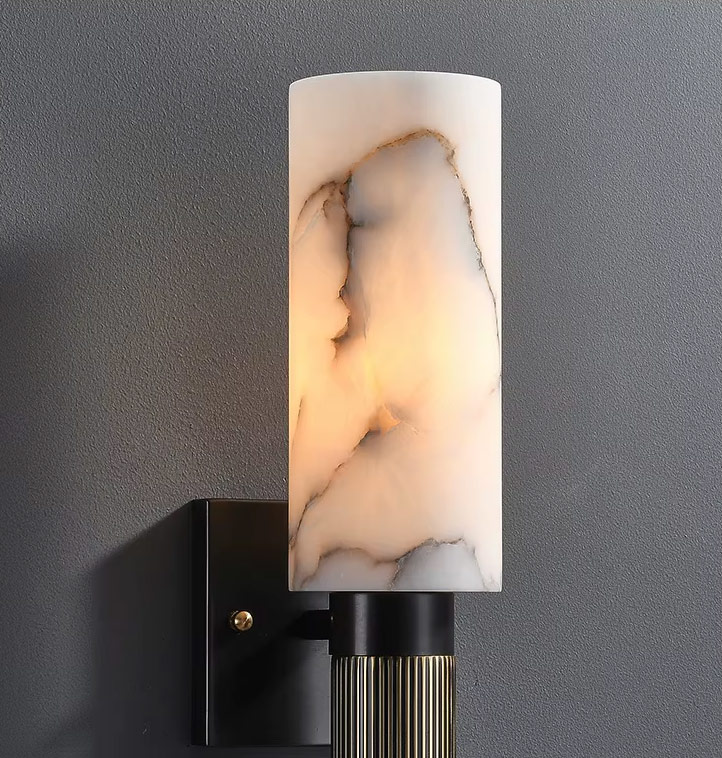 Modern marble wall light with warm ambient glow in a bedroom setting