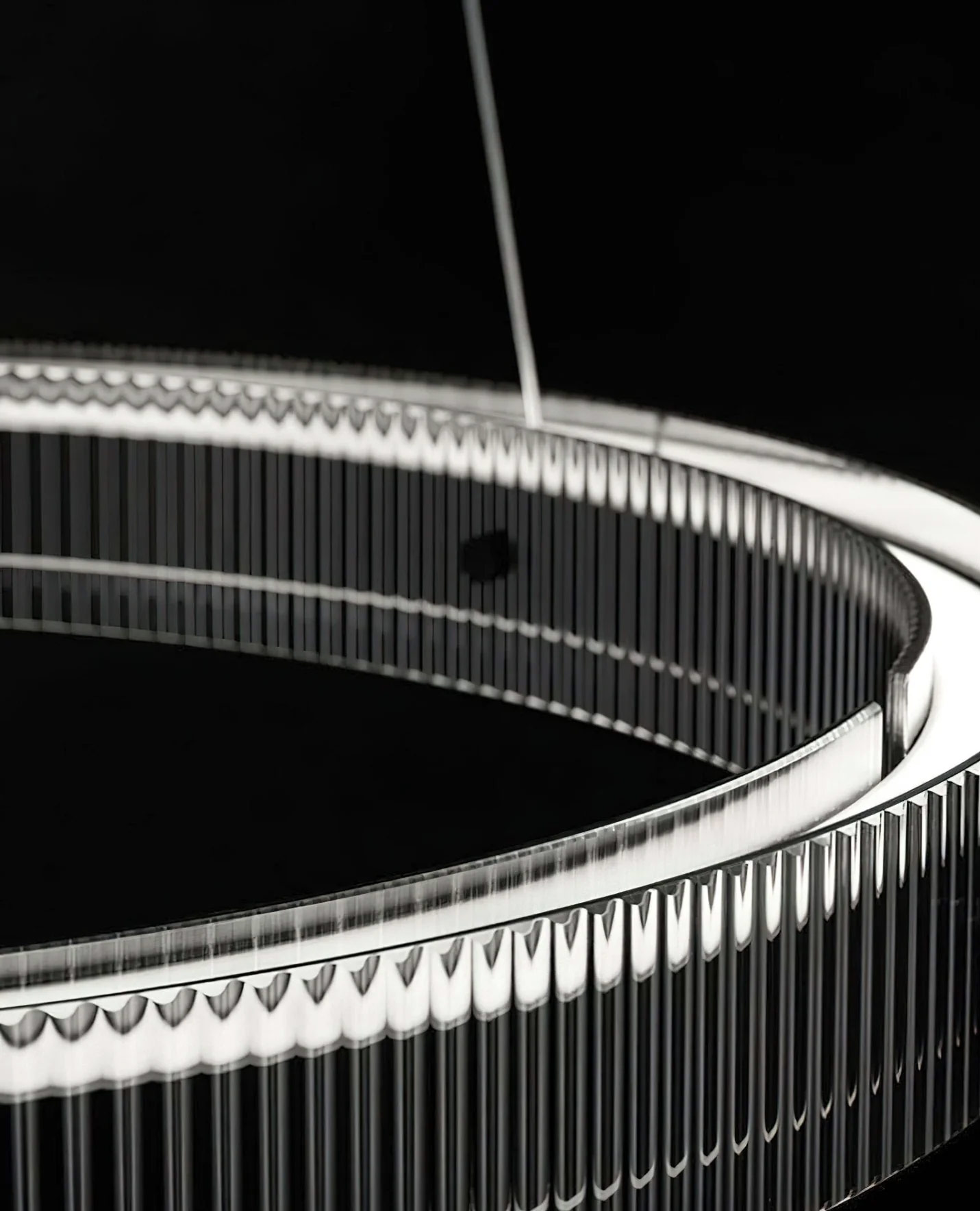 Detailed view of fluted crystal-clear glass ribs and scalloped edge on luxury black LED ring pendant chandelier