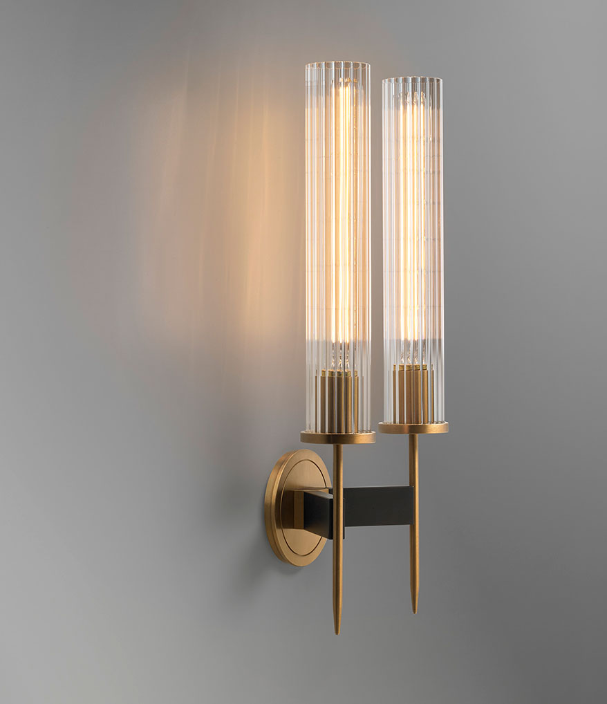 Side view of Avenel double wall sconce showing ribbed glass cylinders and brass-finished metal frame