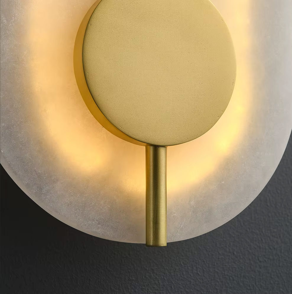 Close-up of brass disc and glass surface with warm backlighting