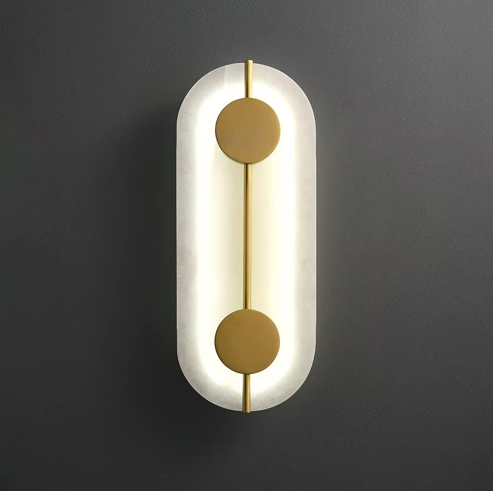 Angled view of illuminated oval wall light on dark wall