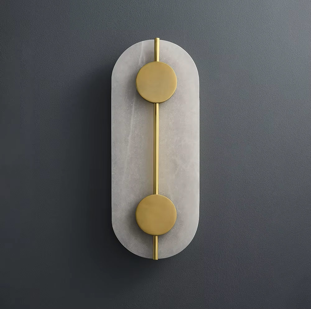 Angled view of wall-mounted oval brass and glass light
