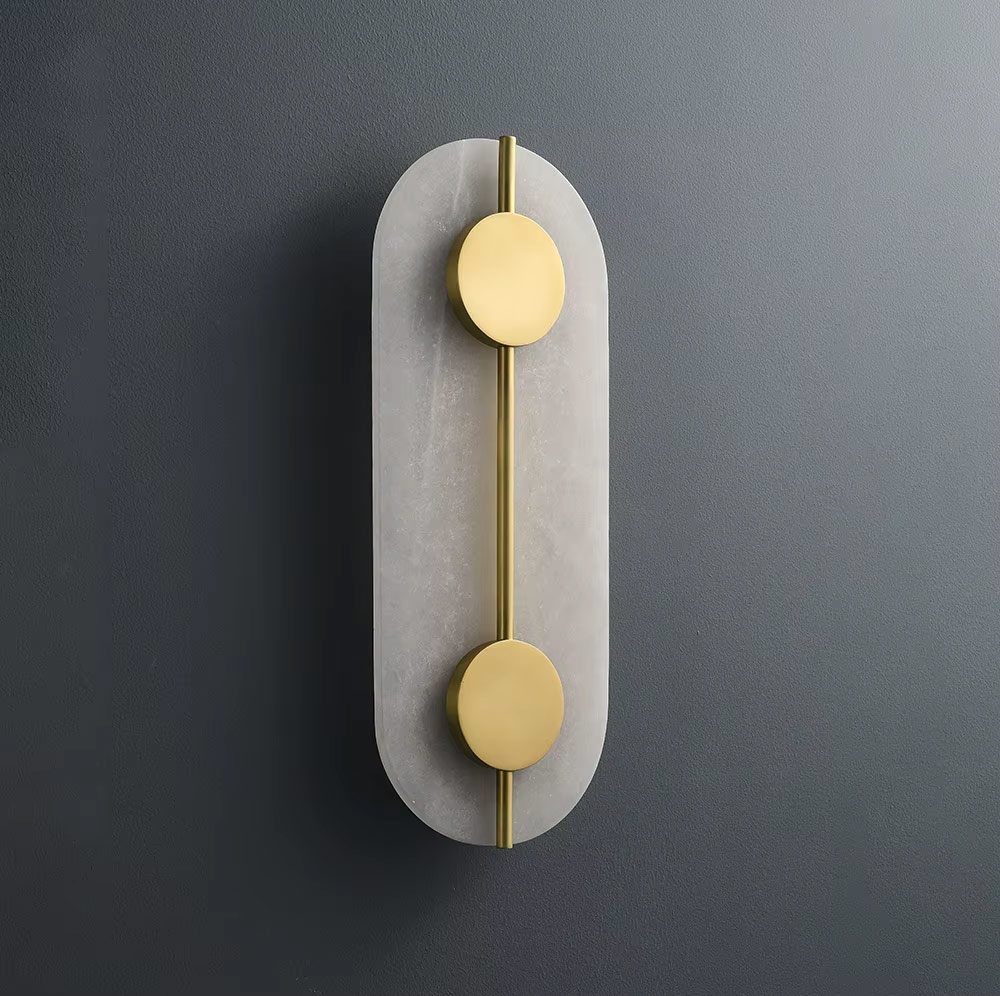 Front view of oval wall light with brass and glass